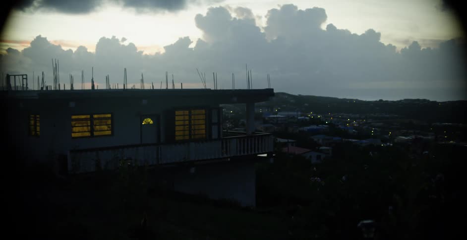 Lights shining inside a building at dawn