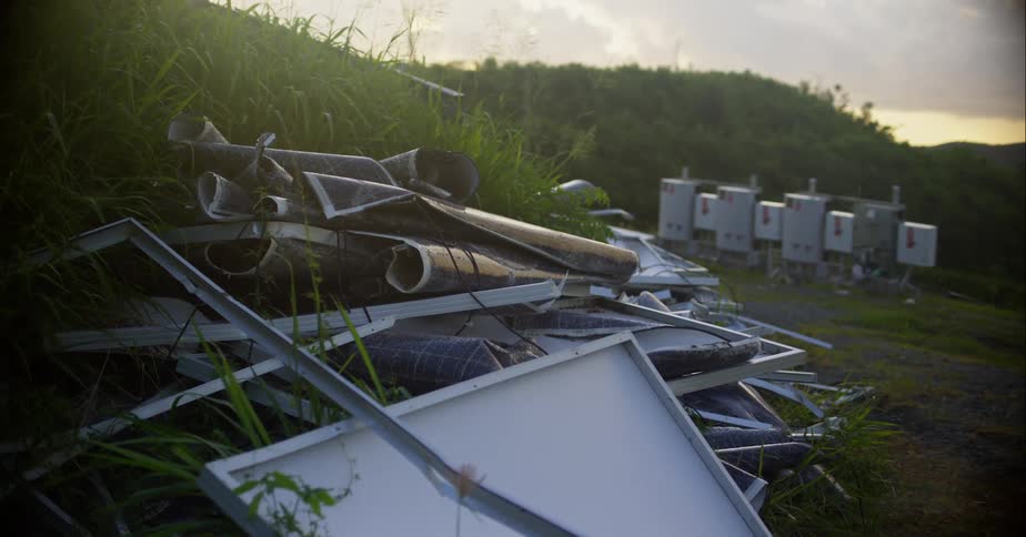 A pile of metal scraps sitting in grass outside at sunset