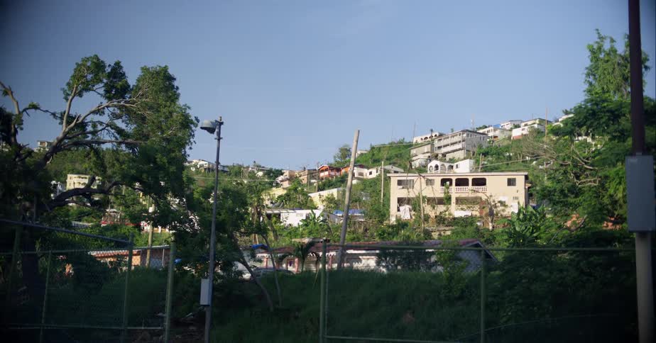 A small town on the slope of a hill on a sunny day
