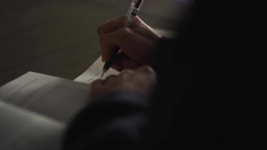 Person taking notes in notebook