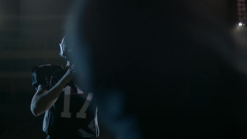 A quarterback passing a football