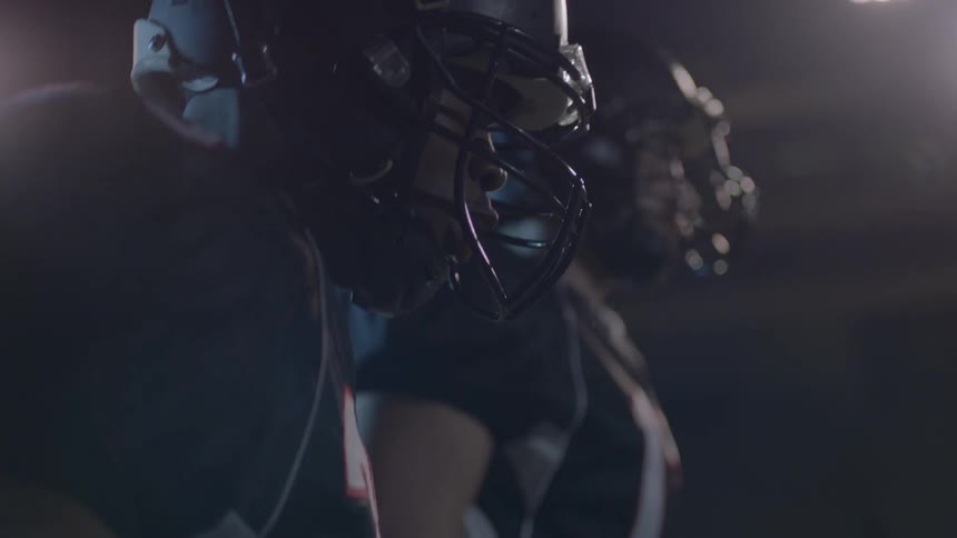 People in football gear jump up and down