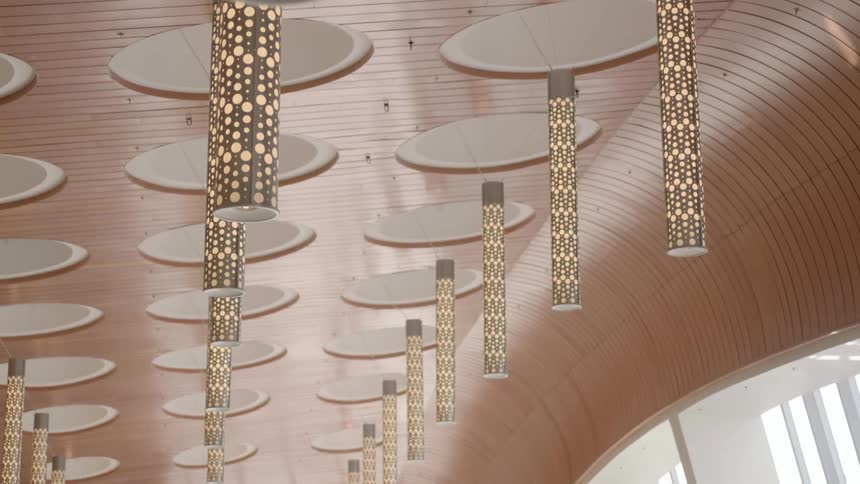 Light fixtures hang from a curved ceiling