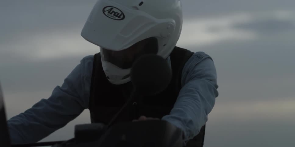 A man is sitting on a motorcycle starting it up