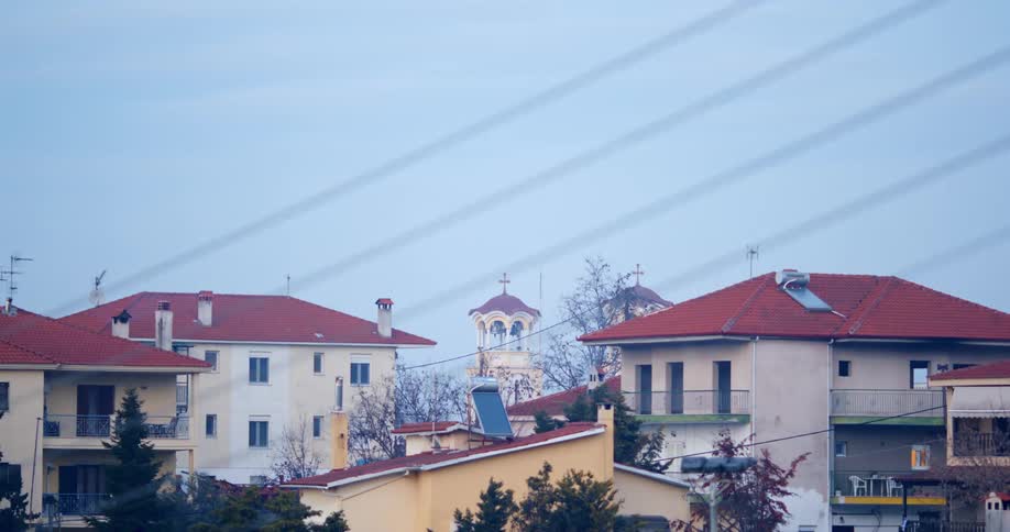 Crosses on church towers show between apartment buildings