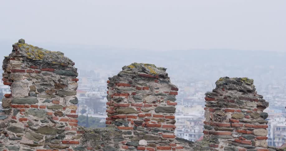 Old brick wall type structure above distant town in valley