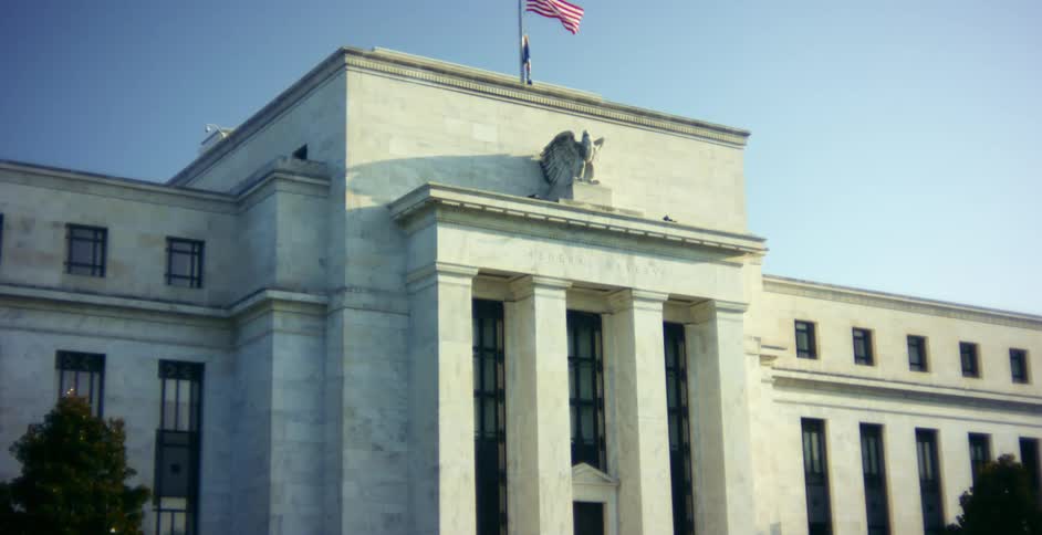 American flag flies at half mast on the Federal Reserve building