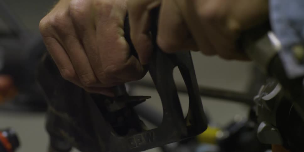 Two hands are gripping a gas pump