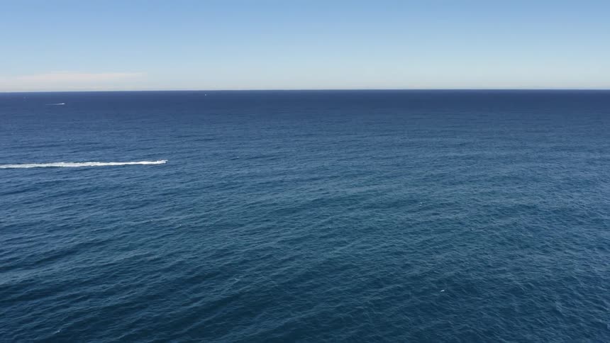 A boat is driving in the ocean