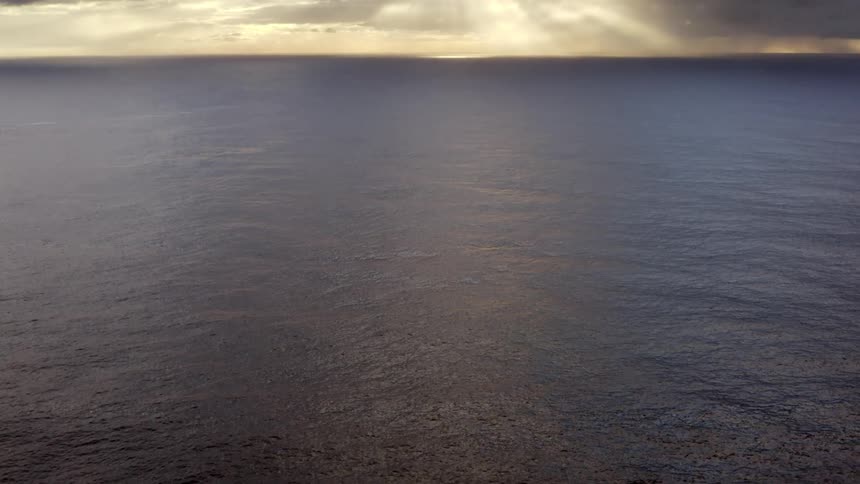 Ocean waves are displayed at dusk