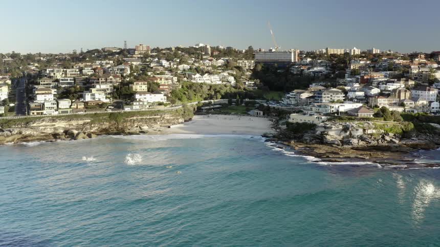 Coastal city next to rocky shoreline and beach
