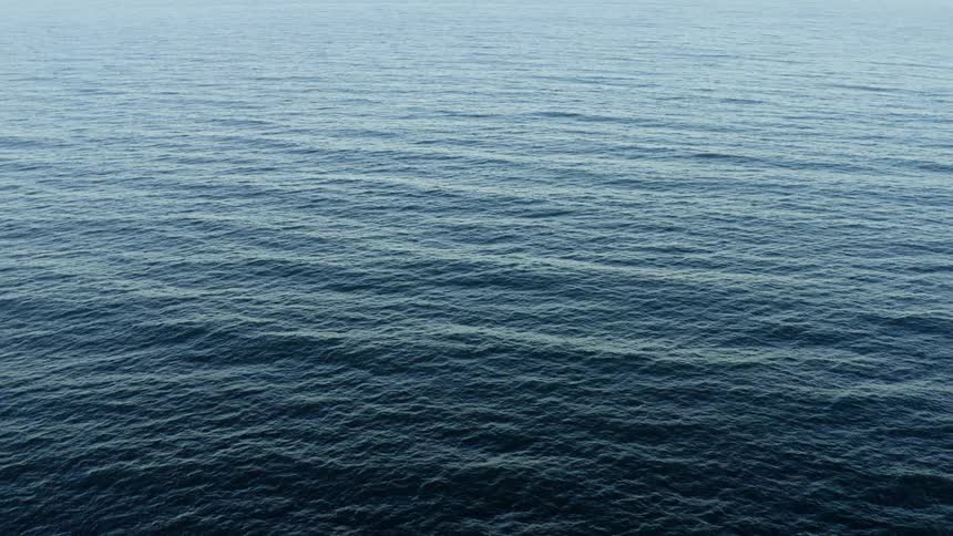 Waves and ripples flow across ocean surface