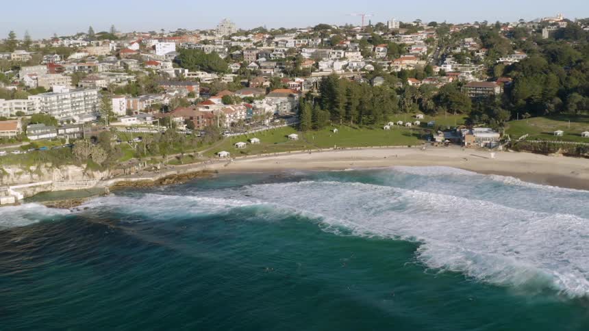 Aerial view of beach and coastal town on peninsula