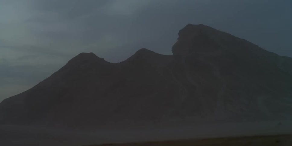 Mist shrouded mountain at night