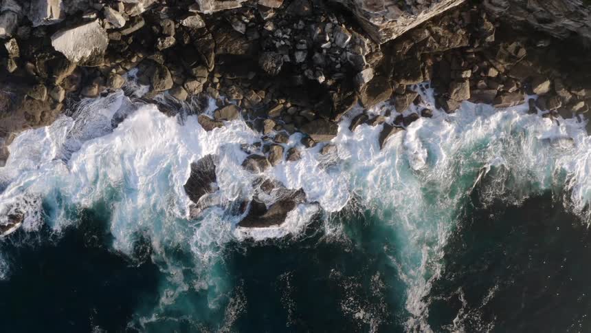 Ocean waves crashing into a rocky shoreline