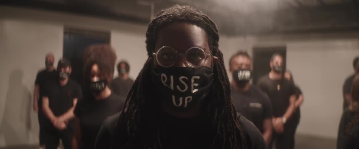 A group of activists stand inside the smoke filled room