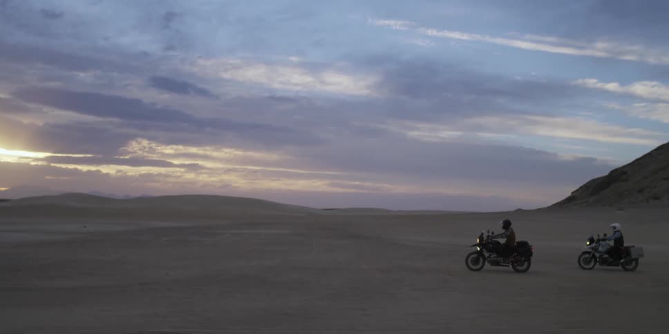 People riding motorcycles through the desert