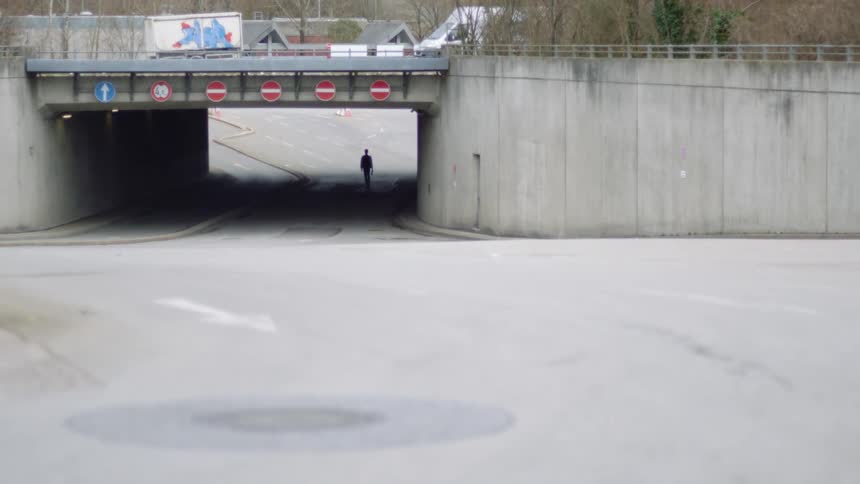 A person walking down the middle of a street