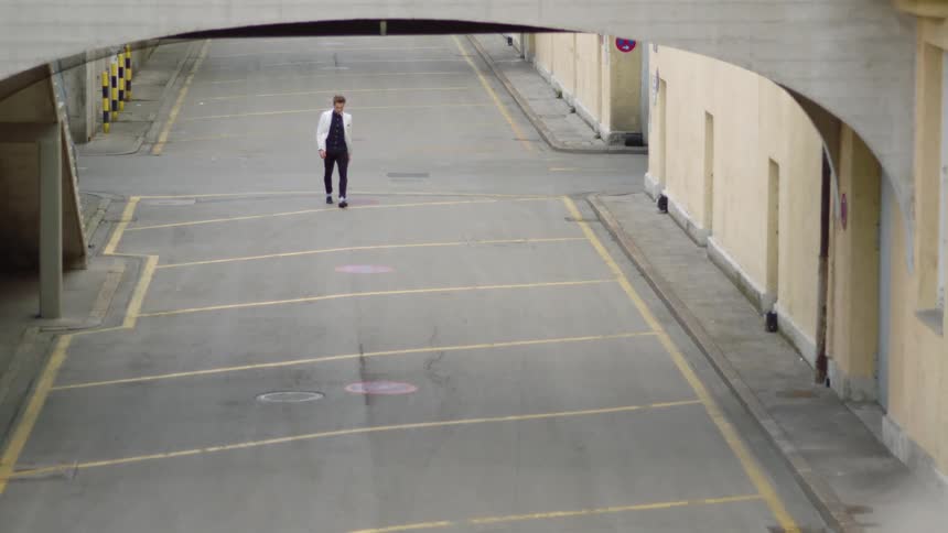 A man is walking down the alley