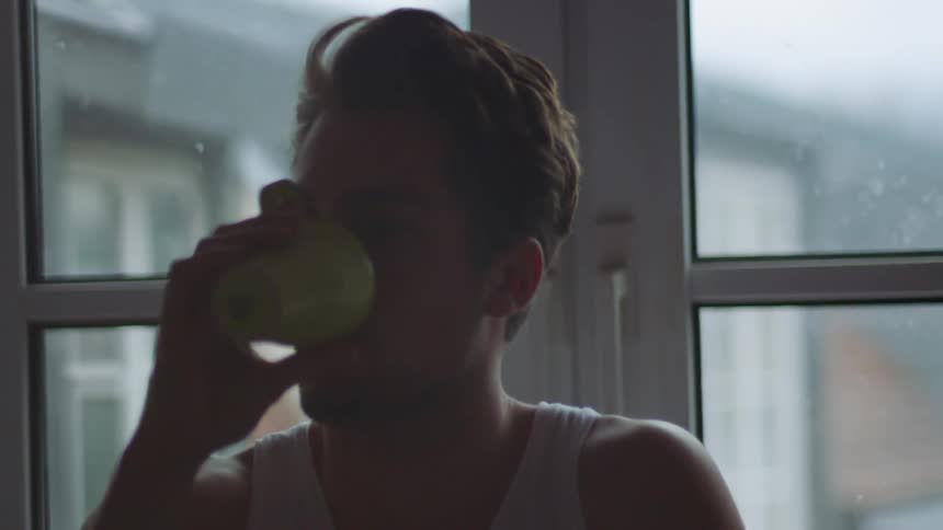 A man drinking coffee at home
