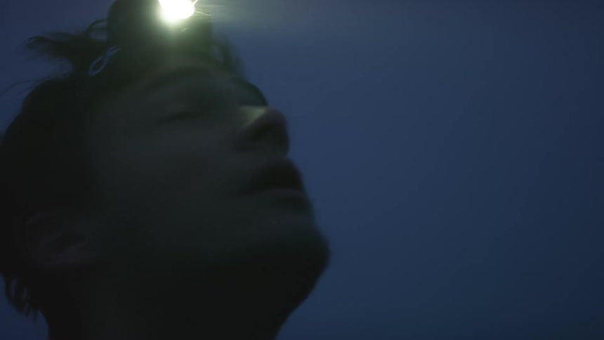 A man is walking outdoors during the night