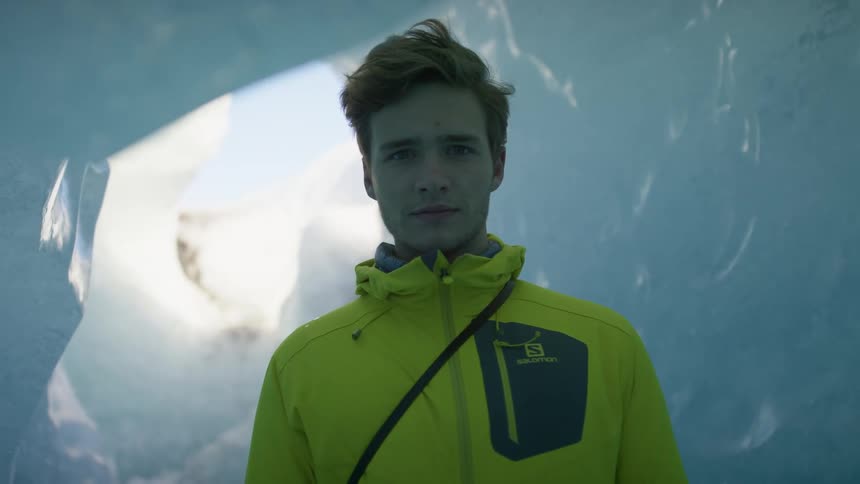 A man standing in an icy cave