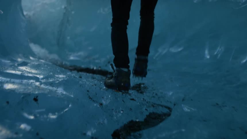 A man hiking through ice tunnels