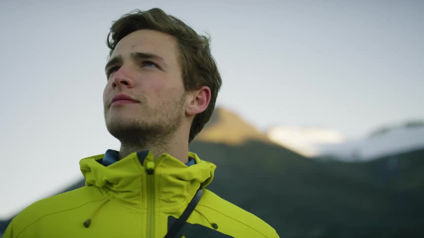 A man is standing outdoors during winter