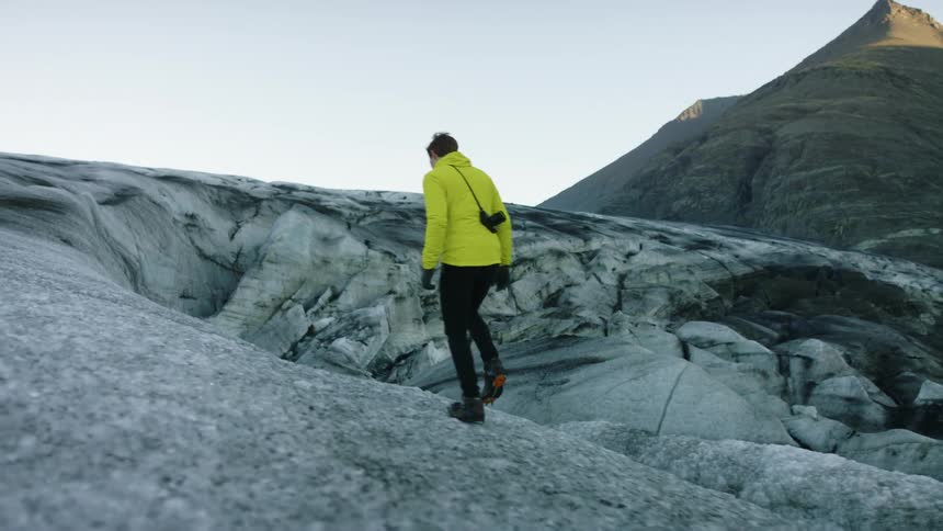 A man is walking up the mountain
