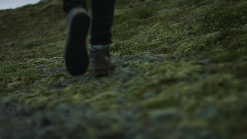 A man walking across the grasslands