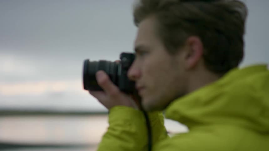 A man is photographing the water