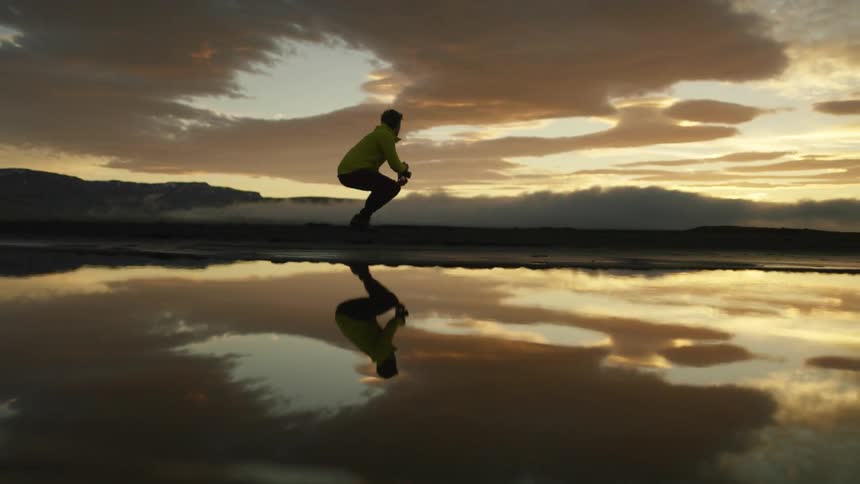 A man is taking pictures of the sunset