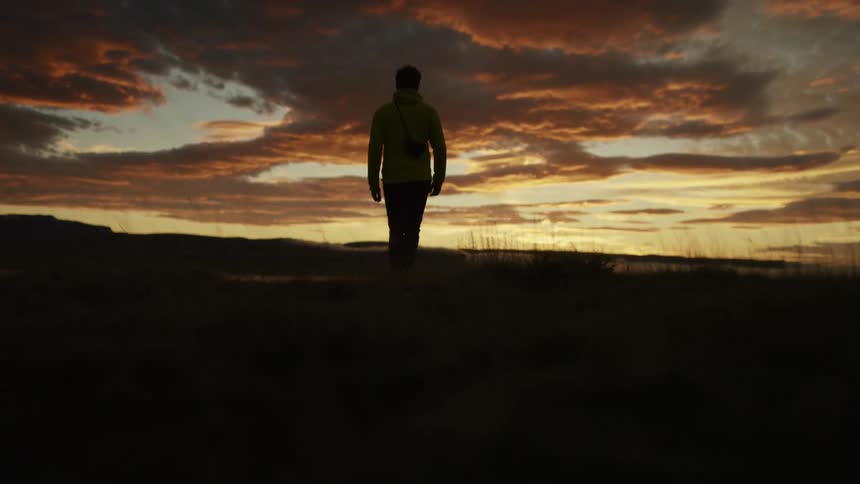 A man walking towards the shore
