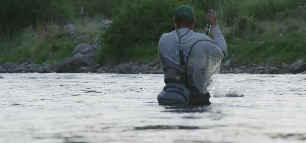 A man is catching fish in the river