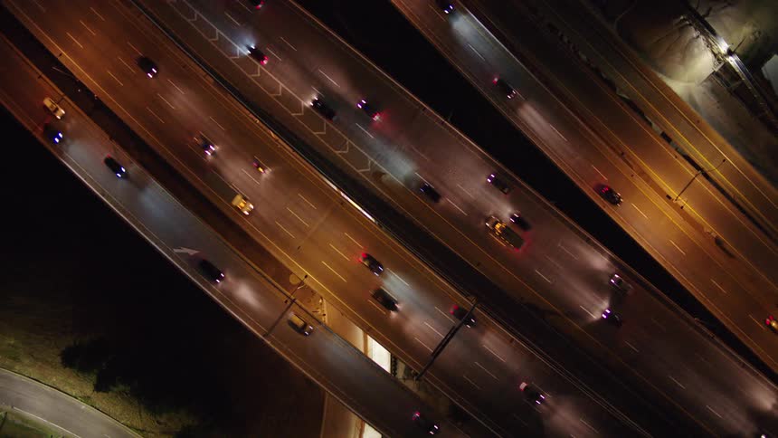 A birds eye view of cars driving on a highway at night