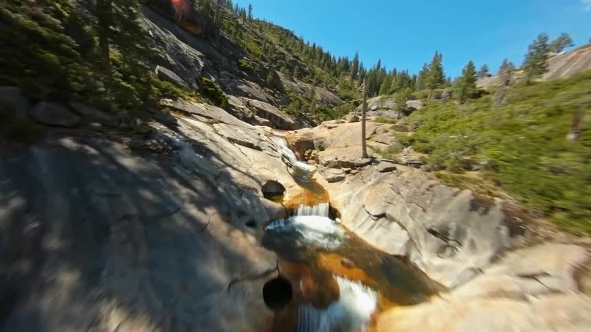 An aerial view of a river flowing through a forest canyon in the wilderness