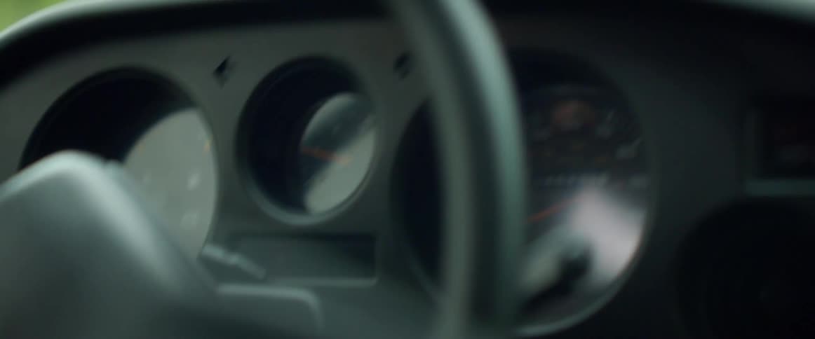 A driver turning a car steering wheel while driving