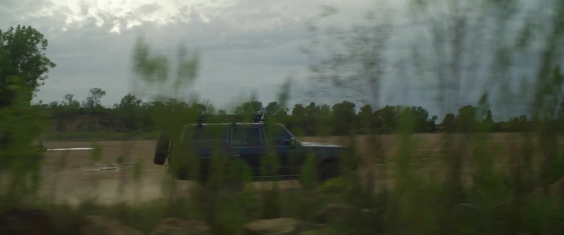 A suv driving off road through a trail