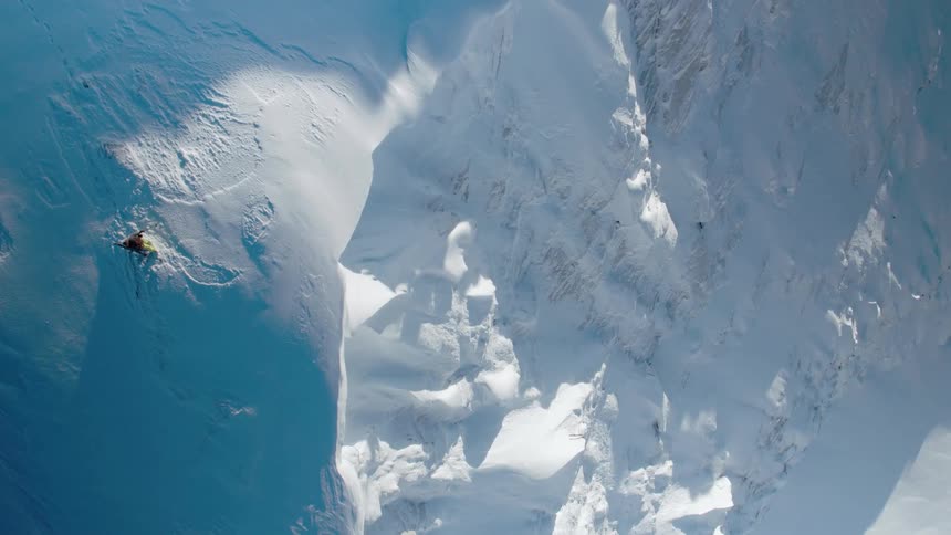 The cliff is covered in heavy snow