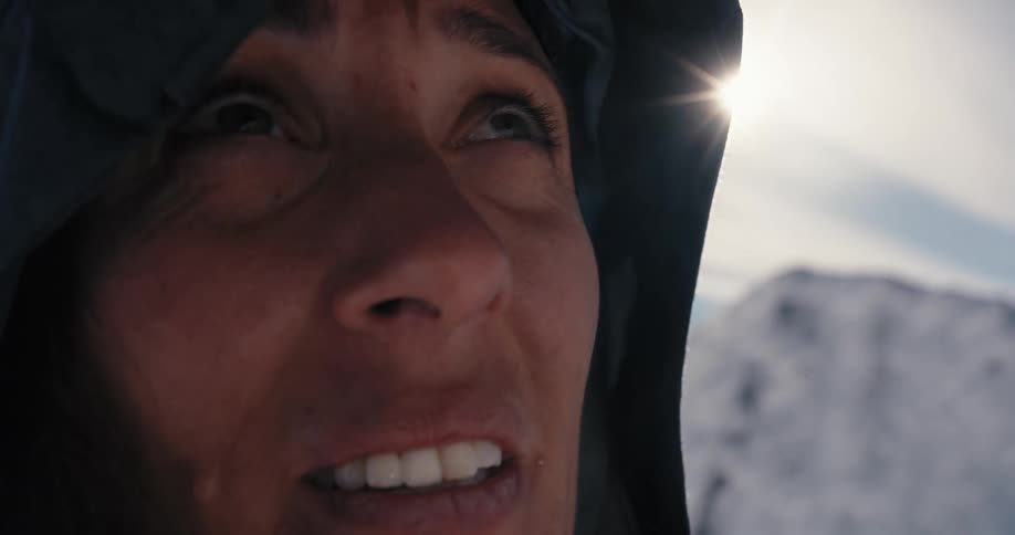A woman is standing outdoors at dusk