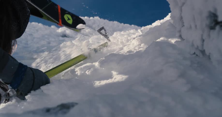 A person is climbing up the mountain covered with snow