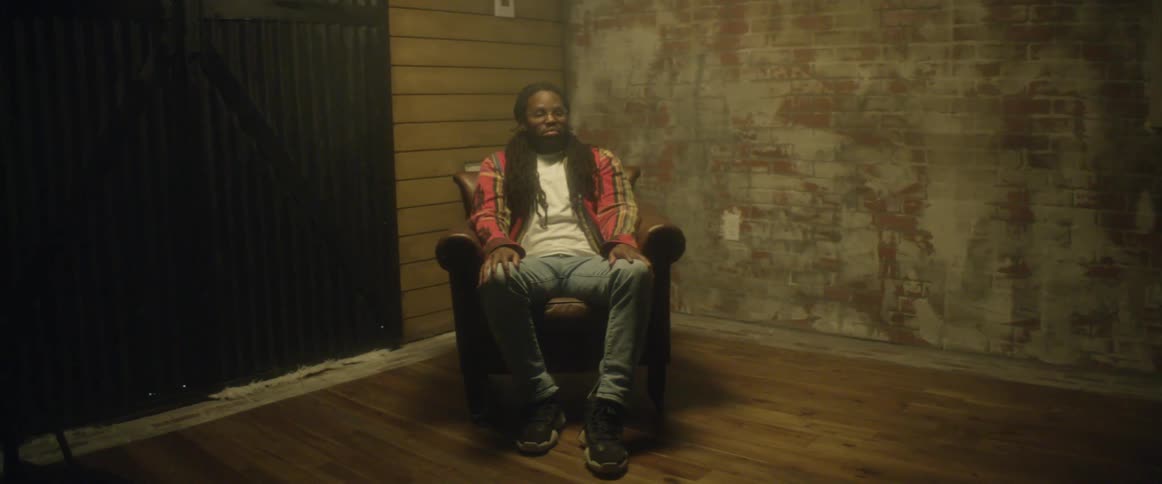 A man is sitting in an empty room