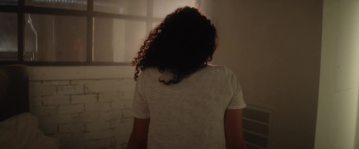 A woman is standing in a dark room