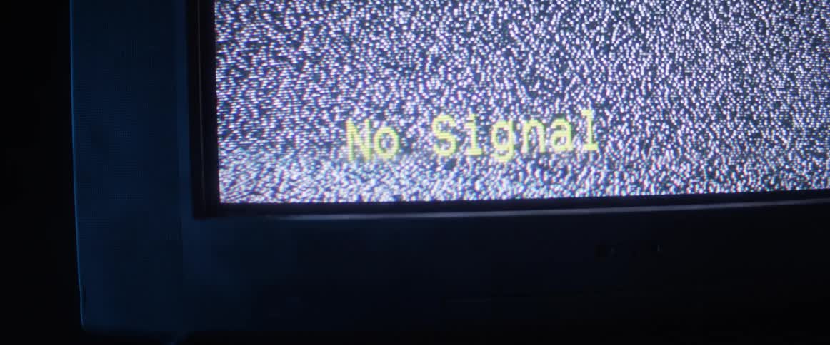 A television screen with statics snow and the word no signal with light flashing