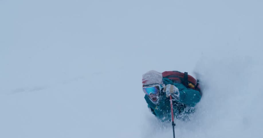 A man skiing down a snow covered hill