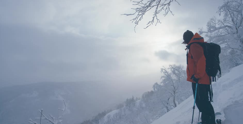 A man standing on skis on a mountain