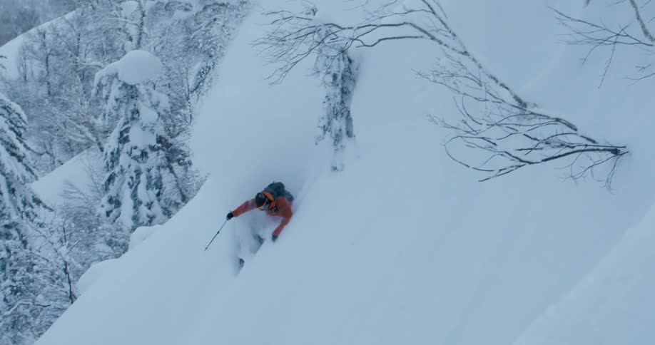 A person skiing down a snowy mountain