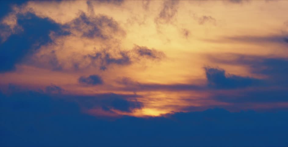 Clouds cover the sun as it sets