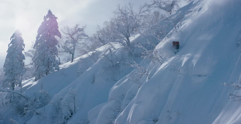 Person skiing on slope on mountainside