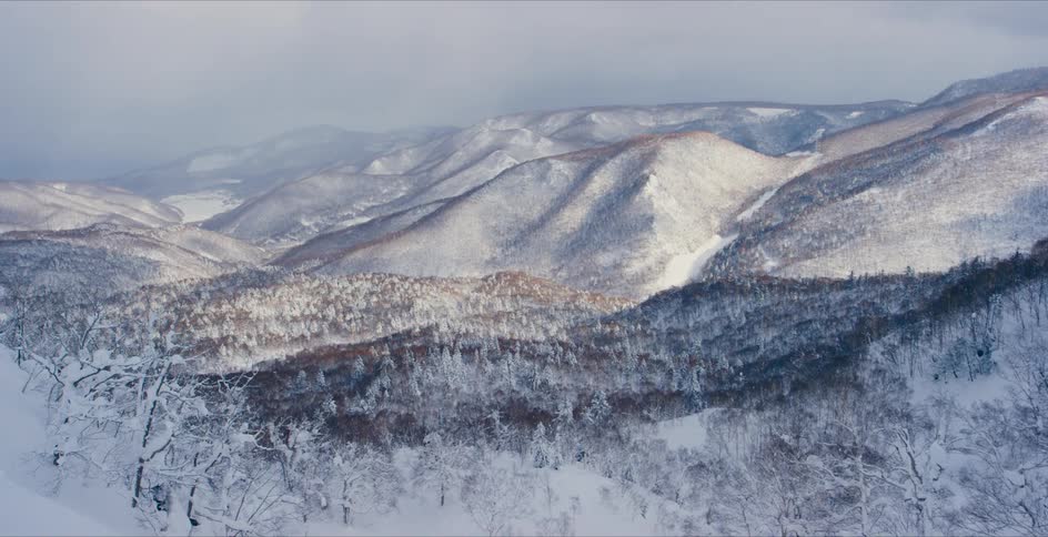 Aerial view of snow covered mountains at dusk